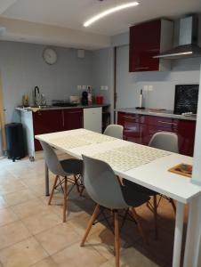 a kitchen with a table and chairs in it at Appartement Saint Sulpice la Pointe in Saint-Sulpice +3 photos