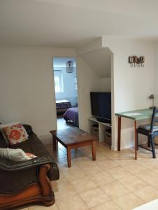 a living room with a couch and a table at Appartement Saint Sulpice la Pointe in Saint-Sulpice