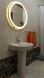 a bathroom with a sink and a mirror at Christmas Arabic Escape Roof Terrace 3 Bedroom Luxury Appartment Superb Location and just 15 mins from El Gouna in Hurghada