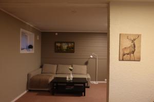 a living room with a bed and a table at Nordic Sauna Retreat in Tromsø