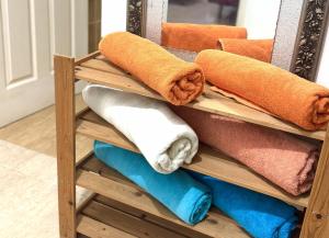 a pile of towels on a shelf in front of a mirror at Haus Megan in Mahe +63 photos