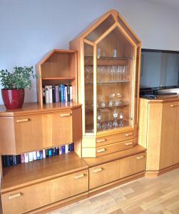 a large wooden cabinet with glasses in it at Appartement Panorama in Gröbming