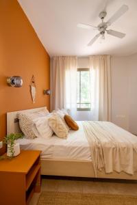 a bedroom with a bed and a ceiling fan at Galilee sea View with Heated Pool in Arbel