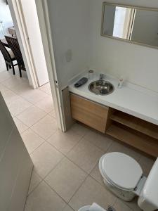 a bathroom with a sink and a toilet at Belgrano Apart in Comodoro Rivadavia