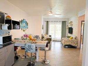 a kitchen and living room with a table and chairs at Coconut Palm Retreat in Flic-en-Flac