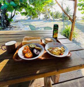 uma bandeja com dois pratos de comida sobre uma mesa em Tetaha Lodge em Tiputa
