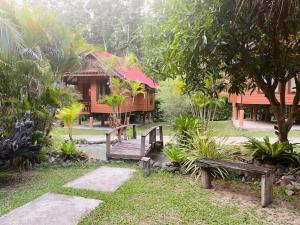 a resort with a wooden bridge and a building at Najjamee Bungalows in Ko Yao Noi
