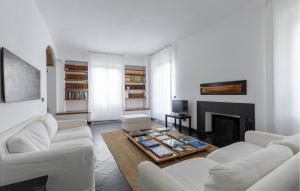 a living room with white furniture and a fireplace at Villa Montefiorito in Recco