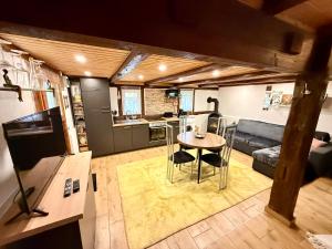 a kitchen and living room with a table and a couch at Casa Jolie in Engen
