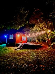 a house is lit up at night with lights at Cabana Betari - Petar in Iporanga