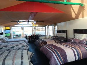 a room with three beds in a bus at cabañas del inka in Puno