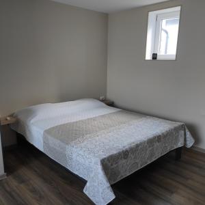 a bed in a white room with a window at Tammiste Holiday House in Tammiste