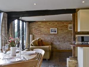 a kitchen and dining room with a table and chairs at The Cart Lodge-E3568 in Uggeshall