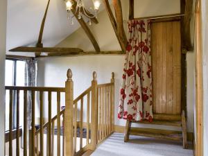 a room with a wooden staircase and a curtain at The Cart Lodge-E3568 in Uggeshall