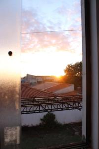 a view of the sunset from a window of a building at Studio11 near Drogasil in Ourinhos +17 photos