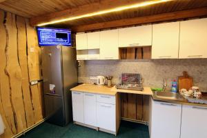 a kitchen with white cabinets and a sink at Еко-садиба "Під ліском" in Yablunytsya