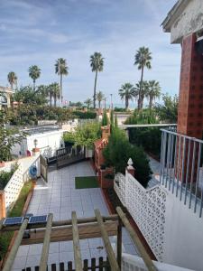 a view of a patio from a balcony with palm trees at El Paraiso de Pepa in Castellón de la Plana