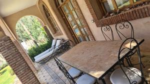 a table and chairs in a room with a window at Ouirgane House in Ouirgane