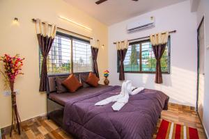 Postel nebo postele na pokoji v ubytování Vaatsalya Villa