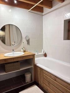 a bathroom with a tub and a sink and a mirror at Brindepaille in Vallon-Pont-dʼArc +31 photos