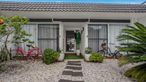 a house with two bikes parked outside of it at The Luxe Waterfront in Sandstone Point