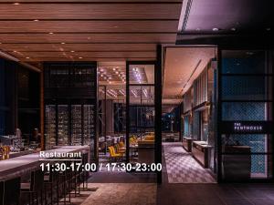 a view of a restaurant with a bar and chairs at Mitsui Garden Hotel Toyosu Premier - Tokyo in Tokyo