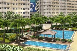 a swimming pool with palm trees and a building at HOPE RESIDENCES UNIT 606 building D in Trece Martires