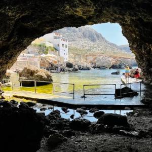 a view of a body of water from a cave at Modern one bedroom Apartment in Żurrieq