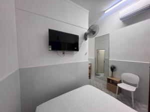 a bedroom with a bed and a tv on the wall at An Nhiên Hotel in Bùi Tiếng +46 photos