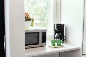 Příslušenství pro přípravu čaje a kávy v ubytování Linnunlahti Hostel + 9 fotografií