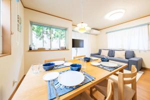 鎌倉市にあるKamakura Hase Houseのテーブルとソファのあるダイニングルーム