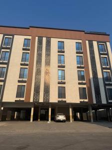 a building with a car parked in front of it at نسمة الخبر سويت in Dammam