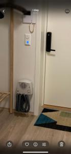 a room with a door with a fan on the wall at Modern apartment with mountain and sea view in Svolvær +32 photos