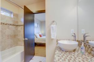 a bathroom with a tub and a sink and a toilet at Urban Roundabout in Bend +18 photos