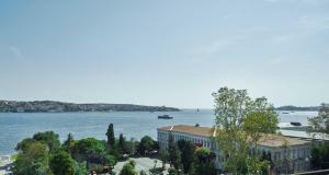 a view of a large body of water with a building at Çırağan Hotel Bosphorus in Istanbul +135 photos