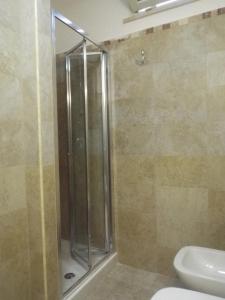 ein Bad mit einer Dusche, einem WC und einem Waschbecken in der Unterkunft veranda sul mare in Bagnara Calabra