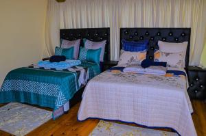 two beds sitting next to each other in a bedroom at E Point guest house in Johannesburg