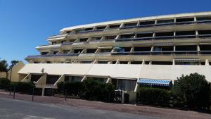 an apartment building on the side of a street at Studio face Mer - Village Naturiste - Cap d'Agde in Cap d'Agde