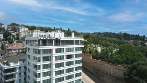 a white building with a sign on top of it at Çırağan Hotel Bosphorus in Istanbul