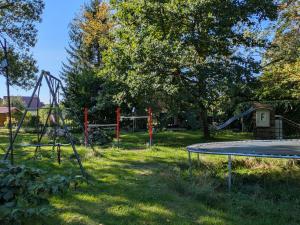 a playground with a trampoline in the grass at Rathsacks Familienhof in Ziegendorf