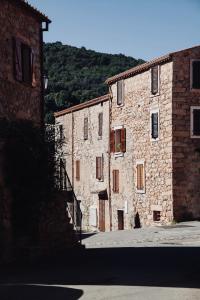 a group of stone buildings on a street at Luna Rossa in Piana