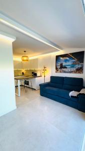 a living room with a blue couch and a table at Bungalow Diana in Maspalomas