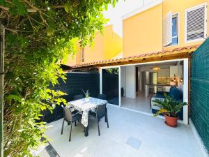 a patio with a table and chairs in front of a house at Bungalow Diana in Maspalomas