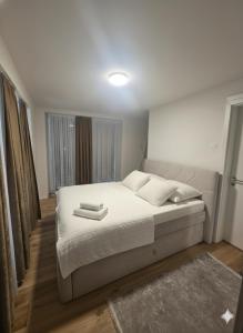 a bedroom with a bed with two towels on it at Lux Line Apartment in Zürich