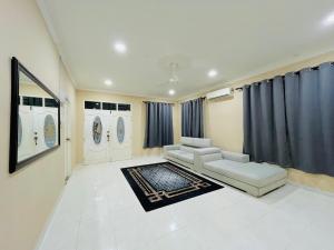 a living room with a couch and a table at Z Homestay in Kuala Terengganu