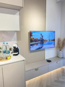 a living room with a tv on a wall at Apartament DeLuxe Zamość Prywatny parking podziemny in Zamość