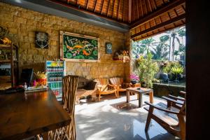 a room with a wooden table and chairs in a room at Kaki Uma Villa in Ubud