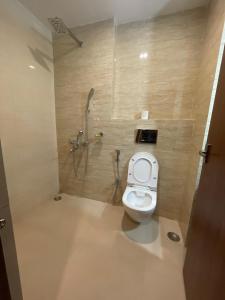 a bathroom with a toilet and a shower at The Imperia in Guwahati