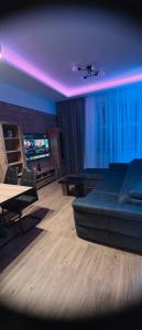 a living room with a couch and a table at Apartament centrum - loft Plac Piłsudskiego in Gliwice