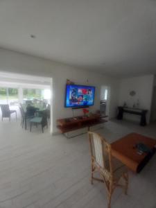 a living room with a flat screen tv on the wall at camping sonho traga seu in São Sebastião
